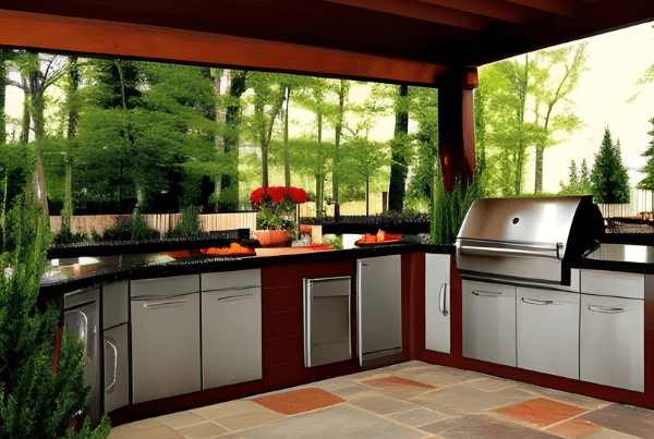 The image showcases an elegant and spacious outdoor kitchen set in a serene backyard. The kitchen features a large grilling station with a range hood, an under-counter refrigerator, and plenty of counter space for food preparation. The high-quality stainless steel appliances contrast beautifully with the rich, dark wood cabinetry. A bar-height counter with seating for four offers a casual dining or socializing area. The kitchen is set against a backdrop of lush greenery, creating a tranquil and inviting environment. This image perfectly represents the concept of outdoor living and dining.